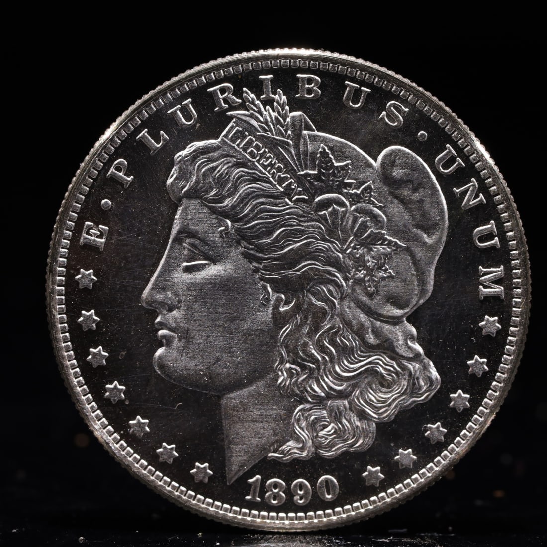 USA Morgan Dollar 1890 Coin: Obv: profile bust with date below and E PLURIBUS UNUM legend and stars around. Rev: eagle with In God we trust above within wreath with UNITED STATES OF AMERICA ONE DOLLAR legend. IN GOD WE TRUST / LI