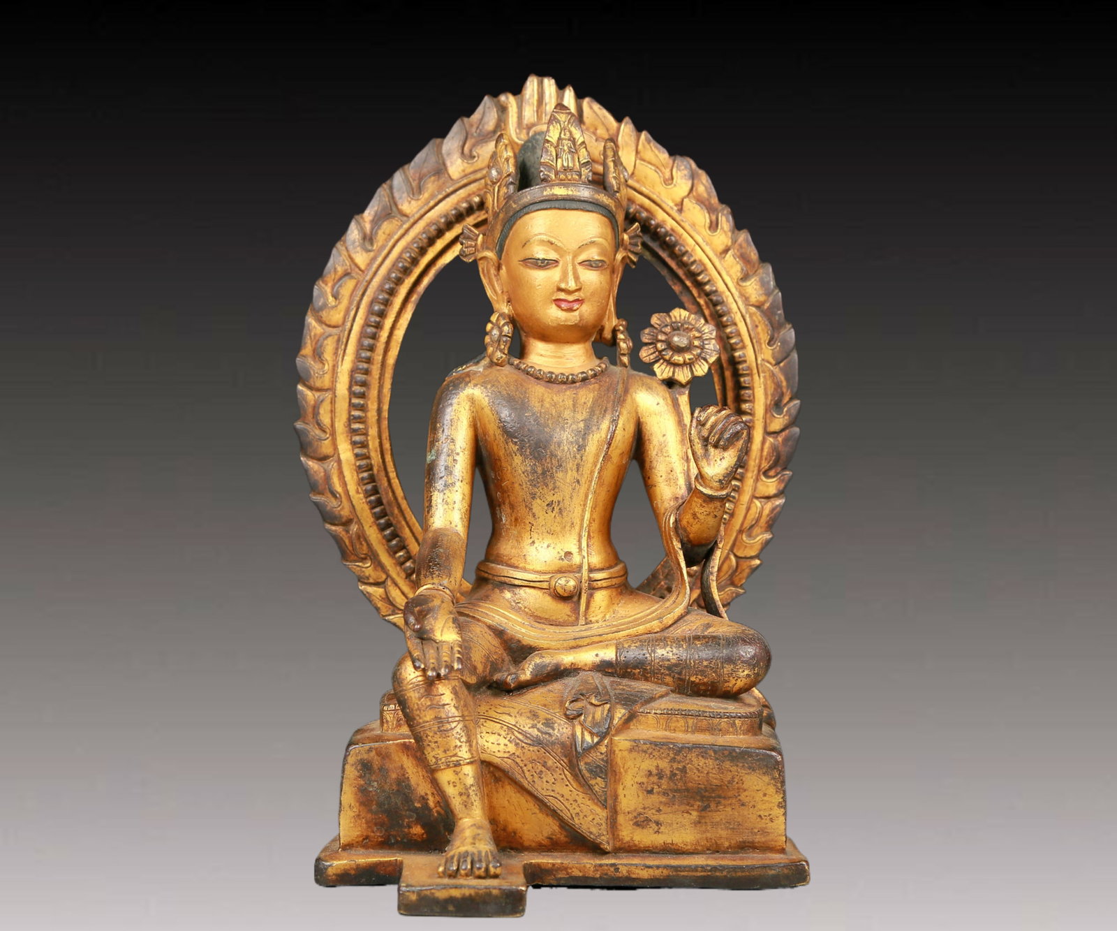 A solemn gilt bronze statue of green Tara: A solemn gilt-bronze green Tara statue with inscription,Ming Dynasty,China. Tara's posture is elegant,with a peaceful and compassionate expression. Her face is soft and A solemn,and her eyes are