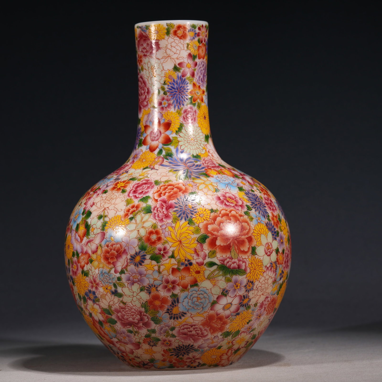 An Exquisite Glass Body Famille Rose Globular Vase With Hundred Flowers Scattering Pattern: An Exquisite Glass Body Famille Rose Globular Vase With Hundred Flowers Scattering Pattern，China, Qing Dynasty, Four-Character Qianlong Mark, Dimensions: 6.3inx6.3inx9.4in, Weight: 1250g，