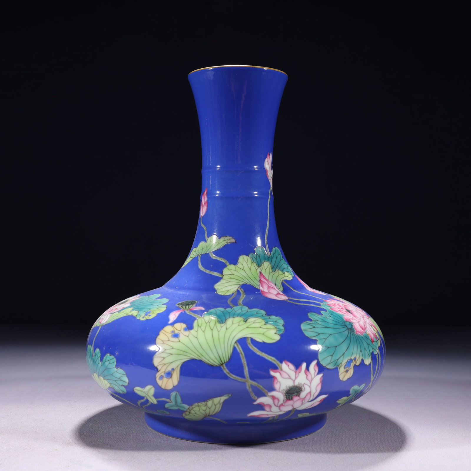 An Exquisite Blue Ground Famille-Rose Painted Gold Lotus Pattern Vase: An Exquisite Blue Ground Famille-Rose Painted Gold Lotus Pattern Vase,Qing Dynasty,China,Yongzheng Four-character Mark,Size:7.9inx10.6in,Weight:1900g 蓝地粉彩描金&#