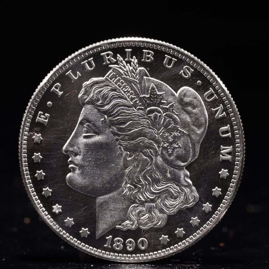 USA Morgan Dollar 1890 Coin: Obv: profile bust with date below and E PLURIBUS UNUM legend and stars around. Rev: eagle with In God we trust above within wreath with UNITED STATES OF AMERICA ONE DOLLAR legend. IN GOD WE TRUST /