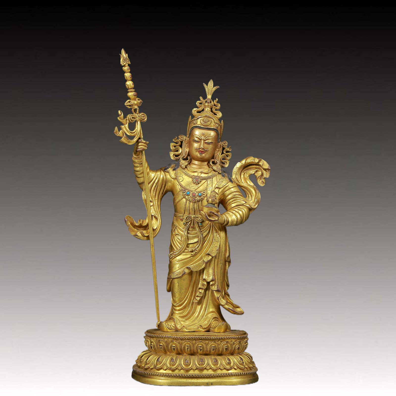 A Magnificent Gilt-Bronze Figure Of Padmasambhava With marks: A Magnificent Gilt-Bronze Figure Of Padmasambhava With marks. Stood on a base, body rendered clad in long, flowing robes, the voluminous drapery elegantly cascading in folds, one hand holding a holy, 