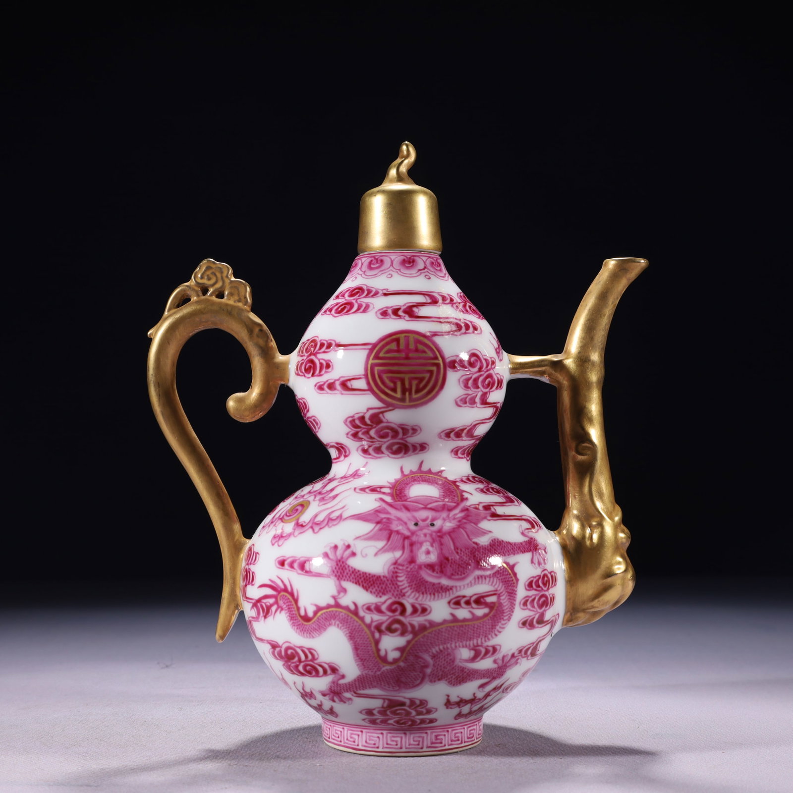 An Exquisite Ruby Red-Glazed Painted Gold Auspicious Cloud and Dragon Pattern Ewer: An Exquisite Ruby Red-Glazed Painted Gold Auspicious Cloud and Dragon Pattern Ewer,Qing Dynasty,China,Qianlong Four-character Mark,Size:6.7inx3.9inx8.7in,Weight:600g