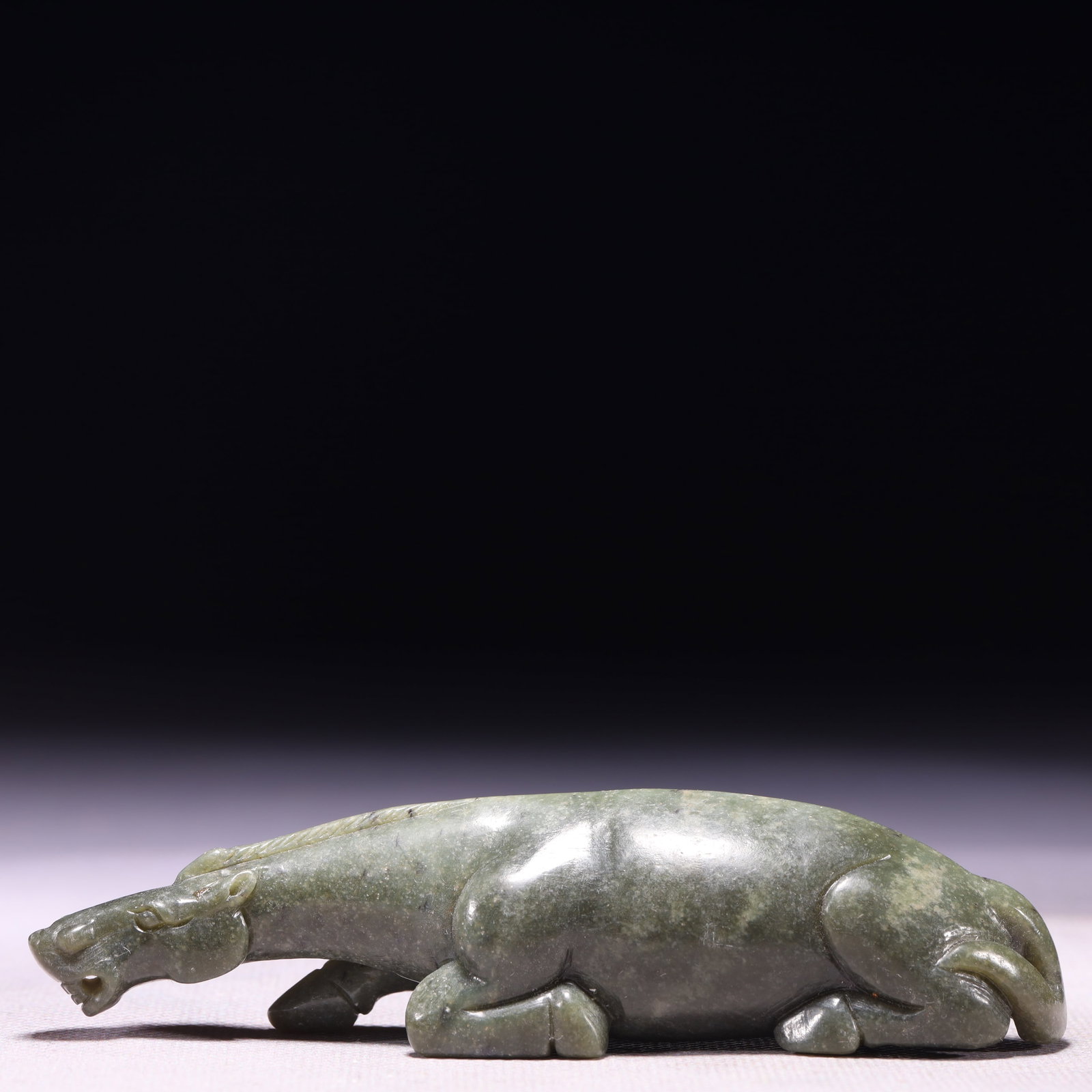 A Rare Green Jade Horse Ornament: A Rare Green Jade Horse Ornament,Qing Dynasty,China,Size:4.7inx1inx1.2in,Weight:131g 青玉骏马摆件,中国清代