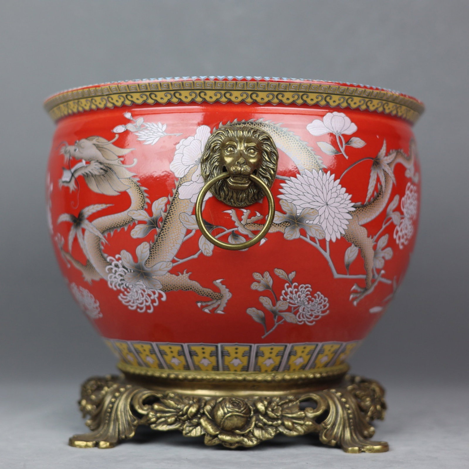 An Exquisite Red Ground Famille-Rose Inlaid Bronze Flower and Dragon Pattern Lion-Ears Vat: An Exquisite Red Ground Famille-Rose Inlaid Bronze Flower and Dragon Pattern Lion-Ears Vat,Qing Dynasty,China,With Mark,Size:10inx12in 红地粉彩镶铜花卉&