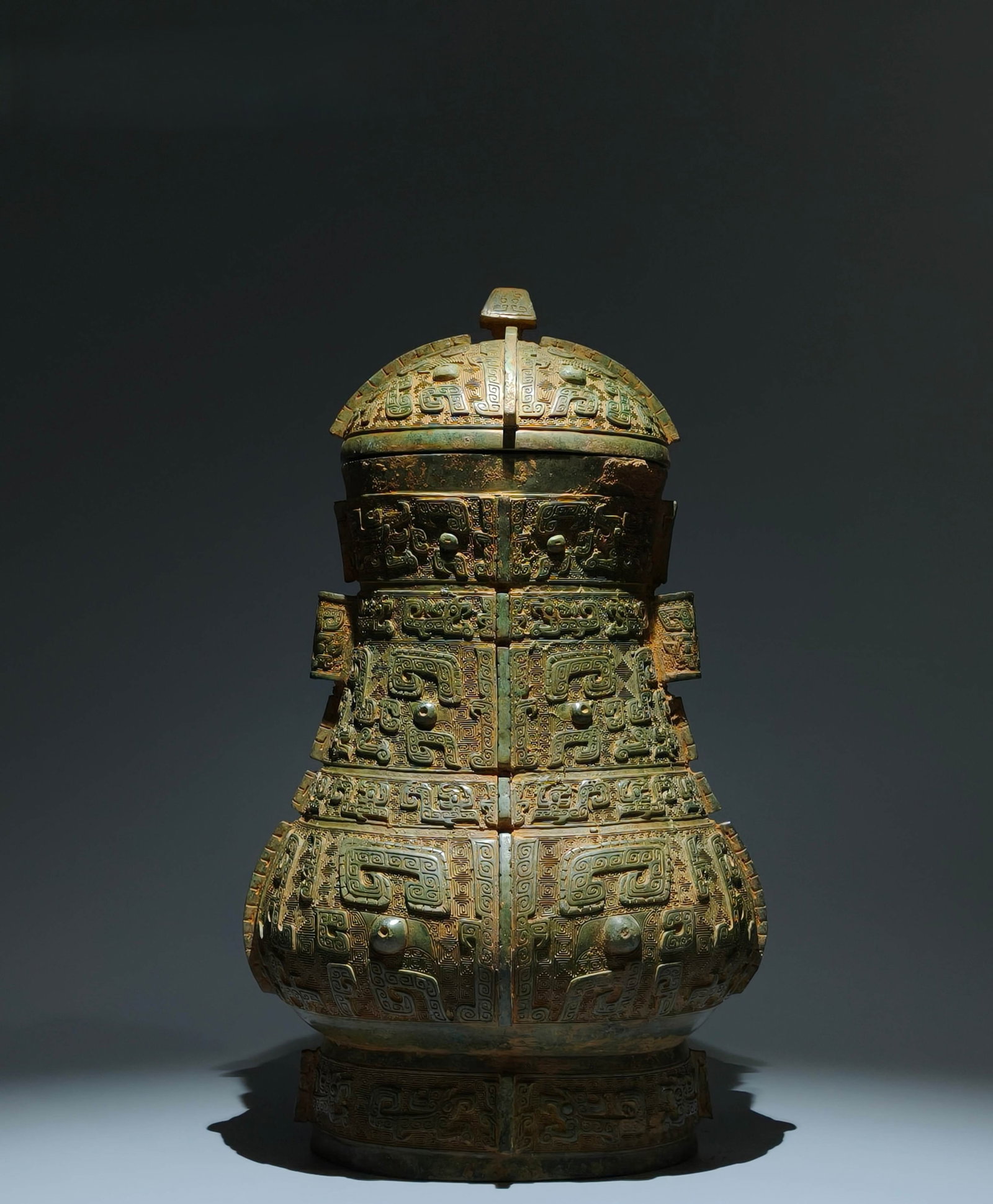 An Archaic Bronze Beast-Face Pattern Pot: An Archaic Bronze Beast-Face Pattern Pot,Shang Dynasty,China,Size:20.9inx11.8inx10.2in 青铜兽面纹壶,中国商代