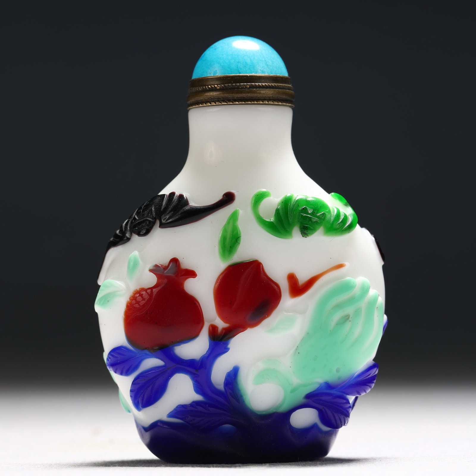 An Exquisite Glass Multi-Color Overlay Bats and Pomegranate Pattern Snuff Bottle: An Exquisite Glass Multi-Color Overlay Bats and Pomegranate Pattern Snuff Bottle,Qing Dynasty, China,Guangxu Four-character Mark,Size:1.8inx0.8inx2.7in 琉璃套彩蝙蝠