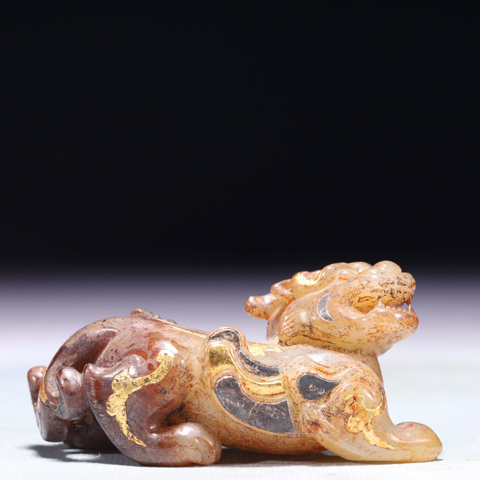 An Exquisite White Jade Inlaid Gold and Silver Beast Ornament: An Exquisite White Jade Inlaid Gold and Silver Beast Ornament,Qing Dynasty,China,Size:3inx1.4inx1.5in,Weight:115.8g 白玉错金银兽摆件,中国