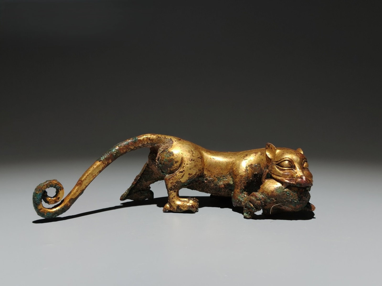 An Exquisite Gilt Bronze Beast Ornament: An Exquisite Gilt Bronze Beast Ornament,the Warring States period in China,Size:2.4inx8.3inx2in 铜鎏金兽摆件,中国战国时期