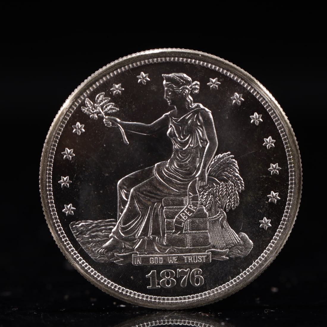 USA Trade Dollar 1876 Coin: American coin. Obverse: Liberty seated on a pedestal facing the sea to the left holding olive branches surrounded by 13 stars. IN GOD WE TRUST / LIBERTY / 1876. Reverse: An eagle holding branches with