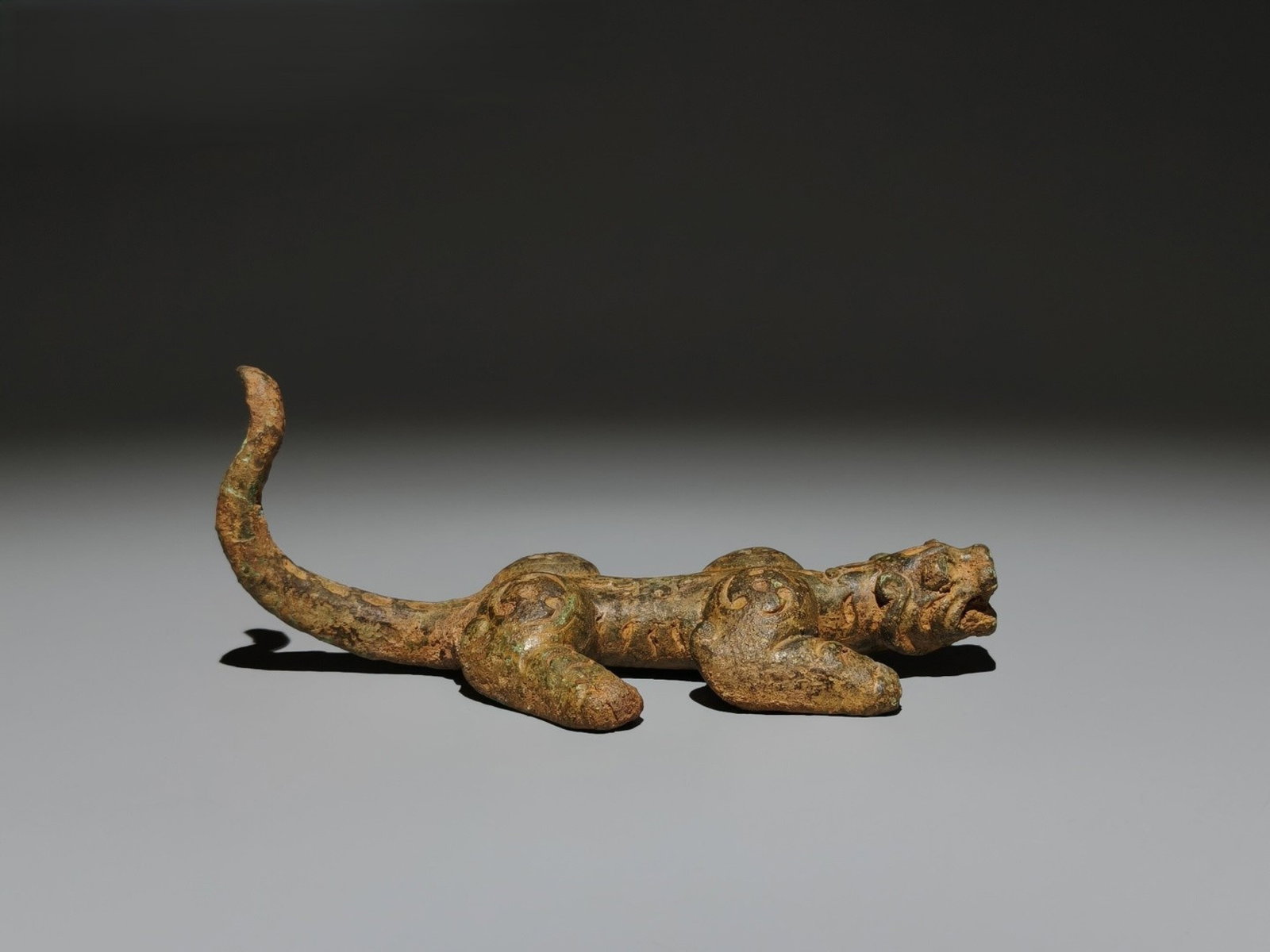 An Archaic Bronze Beast Ornament: An Archaic Bronze Beast Ornament,the Warring States period in China,Size:2.6inx6.3inx3.5in 青铜兽摆件,中国战国时期