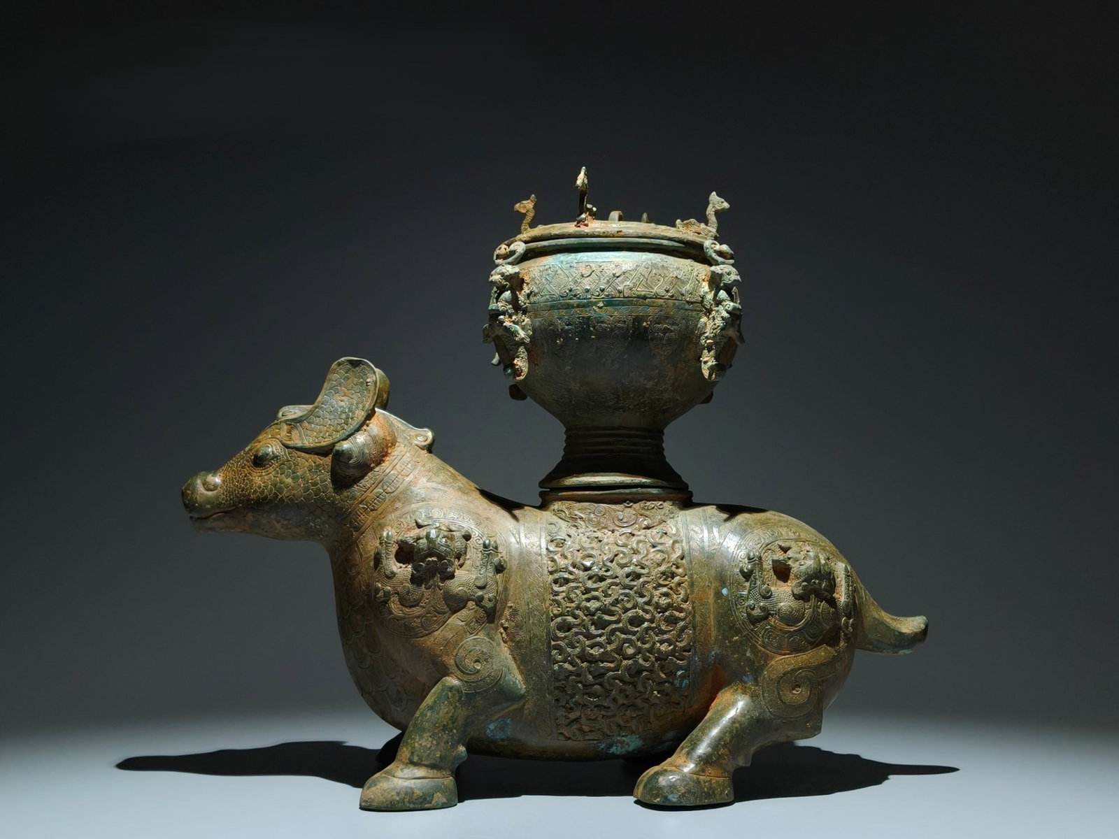 An Archaic Bronze Buffalo Ornament,With Inscription: An Archaic Bronze Buffalo Ornament,With Inscription,the Warring States period in China,Size:14.6inx18.1inx7.1in 青铜牛摆件,带铭文,中国৏