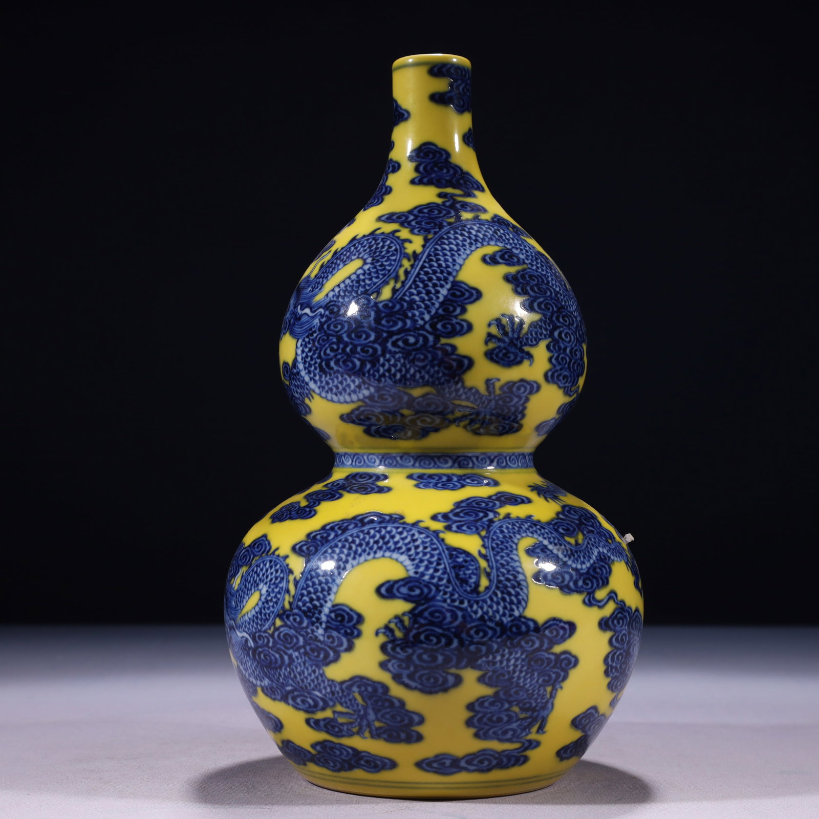 An Exquisite Yellow Ground Blue and White Auspicious Cloud and Dragon Pattern Gourd-Shaped Vase: An Exquisite Yellow Ground Blue and White Auspicious Cloud and Dragon Pattern Gourd-Shaped Vase,Qing Dynasty,China,Qianlong Six-character Mark,Size:5.1inx10.6in,Weight:1150g