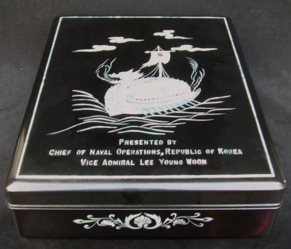 Adm. A. Burke's Presentation Box by Vice Adm. Korea: Black lacquer box with inlays of mother of pearl presented by Vice Admiral Lee Young Woon to Admiral Arleigh Burke. Cased in a custom made, mahogany base and glass surround with a plaque that reads: F
