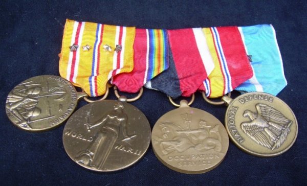 Adm. A. Burke's, Four medals: Medals from the uniform of Admiral Arleigh Burke. Provenance: Arleigh Burke ARTIST: Four U.S. Medals WORK DATE: 20th c. MATERIALS: Brass, guilded brass, enamel SIZE: 4" L. x 3.25" W.