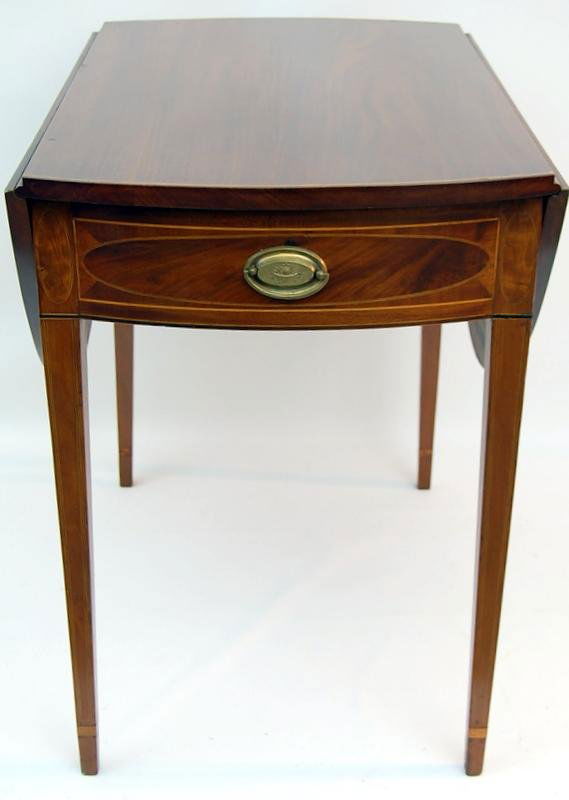 C. 1800 Hepplwhite Table, Mahogany, Pine: Hepplewhite drop leaf table constructed of mahogany and mahogany veneered pine. String band inlayed top. Apron has oval insets with string band inlays. Brass has relief of fruit basket and pineapple.