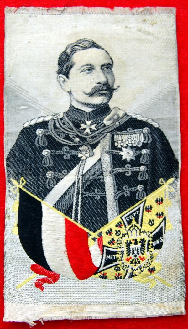 Silk on silk Jaiser Wilhelm II, Mitt Cott UNS: Silk on silk weaving by unknown weaver. Kaiser Wilhelm. Blue,white & red flag and Mitt Cott Uns (God Protect Us) on second flag. Size: 4.75" H X 2.5" W Weight: Less than 1 oz.