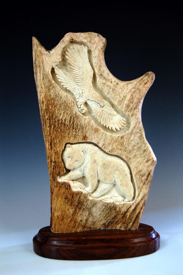 Carved Moose Antler: Carved Moose Antler - Finely done of an eagle over a bear, mounted on a macassar ebony base; 20th C Condition: Excellent Size: 12" H X 7"WX3" D Weight: 1.25 lbs