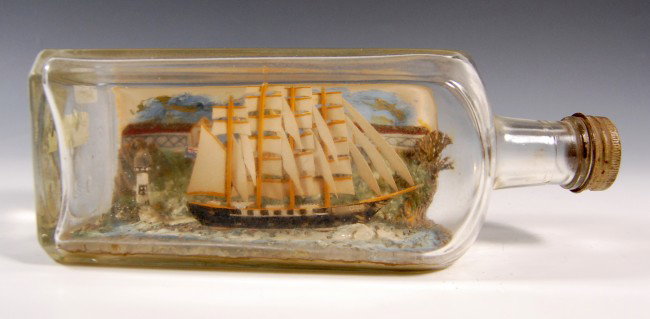 Ship in a Bottle-4 mast Barque 'Speedwell': Ship in a Bottle-4 mast Barque 'Speedwell' - Somewhat 3-dimensional background and 3-dimensional lighthouse. Interior painted sky and water. Metal screw cap. Circa 1930 Condition: Excellent Size: 8.75
