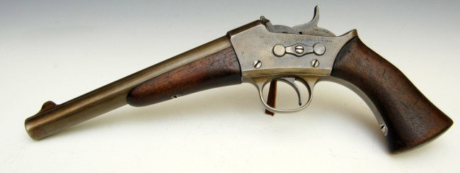 Pistol, Remington Single Shot Rolling Block: Pistol, Remington Rolling Block - Single shot; stamped 'Remingtons Ilion, N.Y. USA' & 'Patent May 3, Nov 15 1864 and April 17, 1866'; walnut grips & stock; Serial # not able to be ascertained due to t