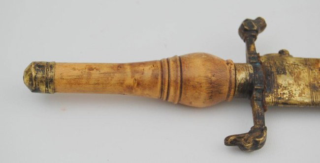 Sword, Hunting, c. 1800-Dog's Head: Sword with curved single edge blade tapering to a double edged blade 5 1/2 from the point. Turned wood grip and cruciform cross guard of brass terminating in different dogs head design. Scabbard of sh