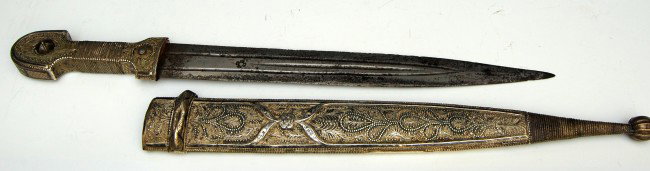 Kindjal, Russian, early 19th C, silvermount: Kindjal, Russian, early 19th C, silver mount, engraved silver; triple fullered, double edged steel blade; retains an amazingly sharp edge & the blade is hallmarked. Knife handle matches the scabbard i