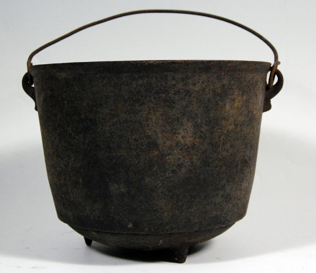 Stew Pot, Footed,, handled cast iron, 19th C.: Stew Pot, Cast Iron, 19th C - footed cast iron pot with the number '7' on the bottom denoting quarts and original carrying handle. Size: 8" H X 19.5" D Weight: 5lb 14.2oz Condition: light, overall rus