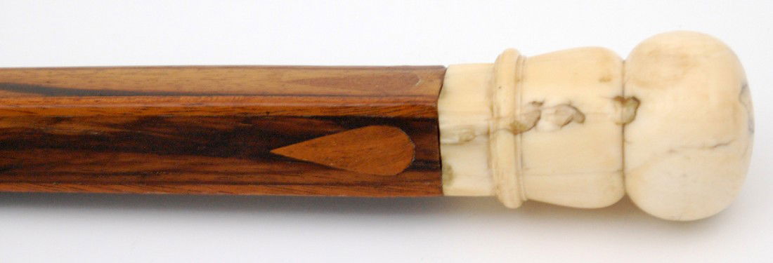 Cane-whale ivory knop Macassar ebony inlaid shaft: Scrimshaw whaler's cane of highly polished, Macassar ebony shaft in octagonally shaped base and leading to a square upper shaft with extremely tight fitting inlays. Inlays are mahogany in teardrop for