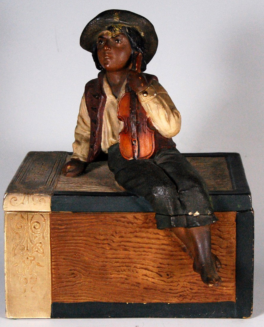 Tobacco jar, Boy w/ Violin, Johann Maresch Co. Han: Hand painted ceramic, figural, two piece, tobacco jar, boy with violin sitting on a cigar box marked Habana, Cigares, Colorado. Incise marked on the bottom JM for Johann Maresch Company, Austria and t