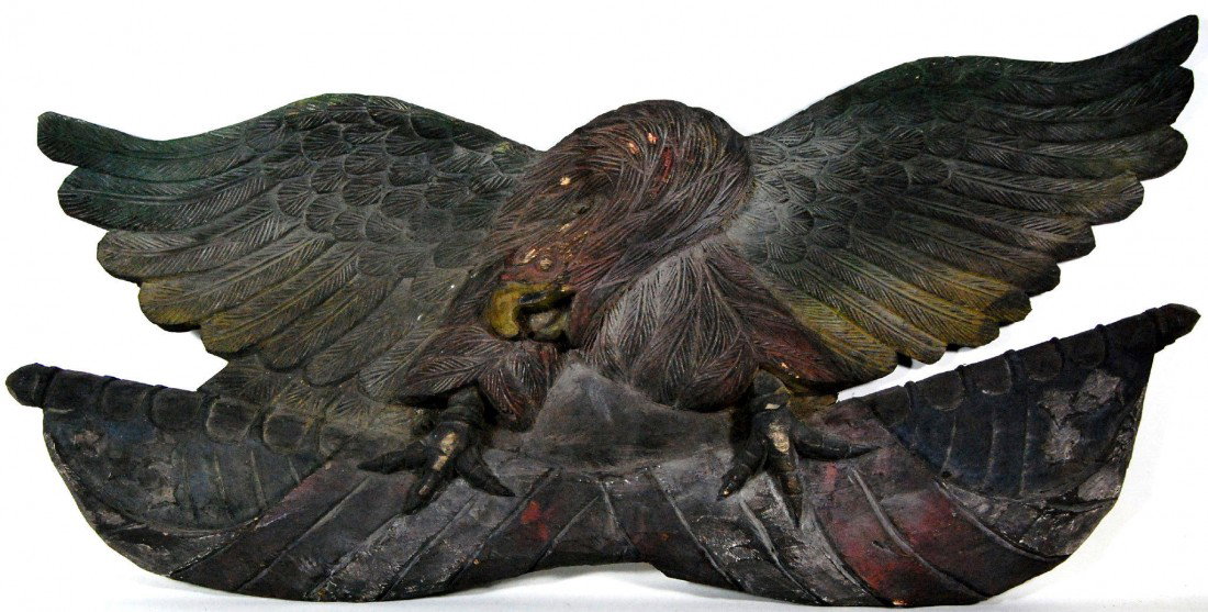 Patriotic Eagle, Carved Wood , 20th C. Patriotic e: Patriotic eagle clasping crossed American flags in its talons with well articulated feathers. Hand Carved from a single block of pine and paint and stain decorated in subdued colors including red, blu