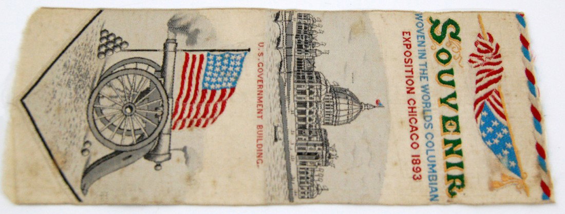 US Government Building at Chicago Expo. 1893 Woven: Woven silk ribbon souvenir of the U. S. Government building at the Chicago Exposition in 1893. Cannon, cannon balls and American flag also depicted. Size: 6 1/2" L x 2 1/2" W Condition toned very slig