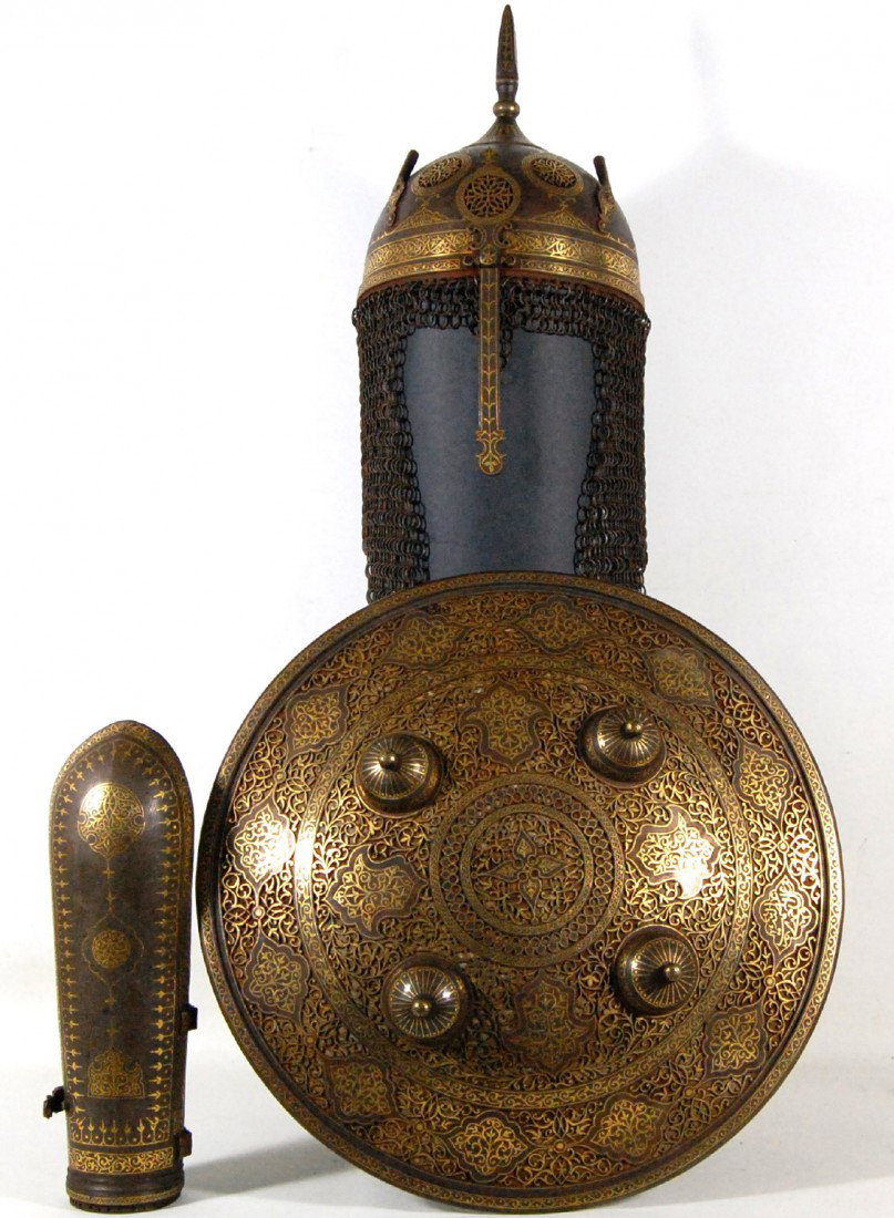 Armor Ensemble, Gilt-Decorated Mughal, 18th c.: Armor Ensemble, consisting of a Helmet, Shield & One Bazuband, Mughal , 18th century. 1. Shield: Finely wrought iron or steel with a phenomenal amount of delicate openwork cutouts. Chiseled inlays of 