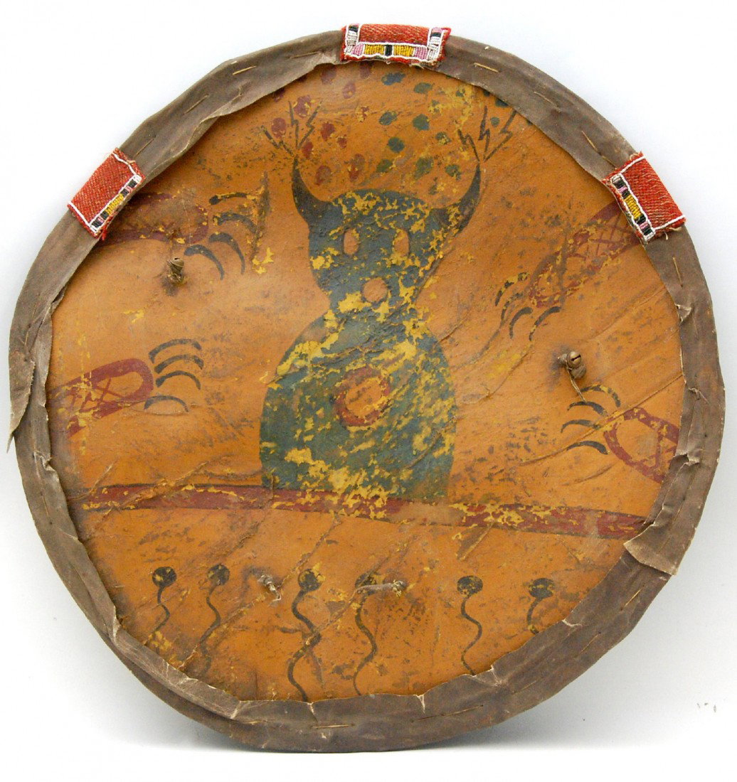 Mid 20th century War Shield, Plains Indian Mid 20t: Mid 20th century Plains Indian War Shield constructed of buffalo and deer hide and paint decorated with an image of a cat. Sewn over a hard base. D: 21 1/2in Weight: 4 pounds Condition: Some loss to l