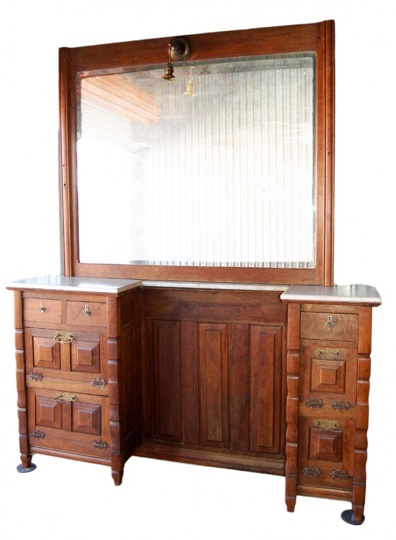 Barber Back Bar From Kentucky Shop, 19th C: 19th century barber back bar from a Kentucky barber shop. The cabinet in walnut with raised panel doors and center, having white marble tops with elaborate escutcheons. A large beveled glass mirror in