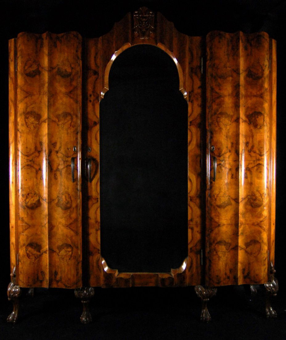 Armoire, walnut, Mario Mascheroni, Milan: Armoire in three sections by Mario Mascheroni, Milan and retaining his original label. In highly figured walnut the center section is a beveled, mirrored door, while the flanking sections are solid. C