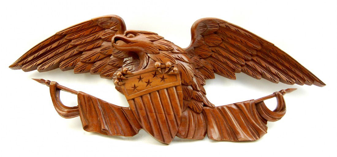 US Eagle Carving - Bellamy style, teak: US Eagle Carving in the style of John Haley Bellamy. Constructed of two piece laminated teak, the work depicts two draped flags or buntings below an eagle clutching a shield with stars in its talons.