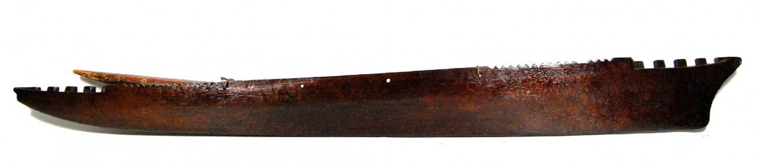 War canoe model, Pacific Islands, 19th century: Antique Pacific Islands war canoe model with outrigger. Stone carved mahogany dating to the 19th century. The outrigger is not attached(see images) but is drilled for fastening of it as well as use fo