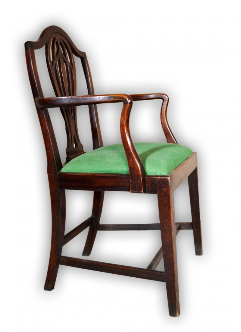 Armchair, Mahogany, Hepplewhite Circa 1795: A mahogany armchair with shield-back, period Hepplewhite armchair along with carved splats in an inverted heart cut out at the base. The arms are serpentine along with tapered legs. Made in Maryland o