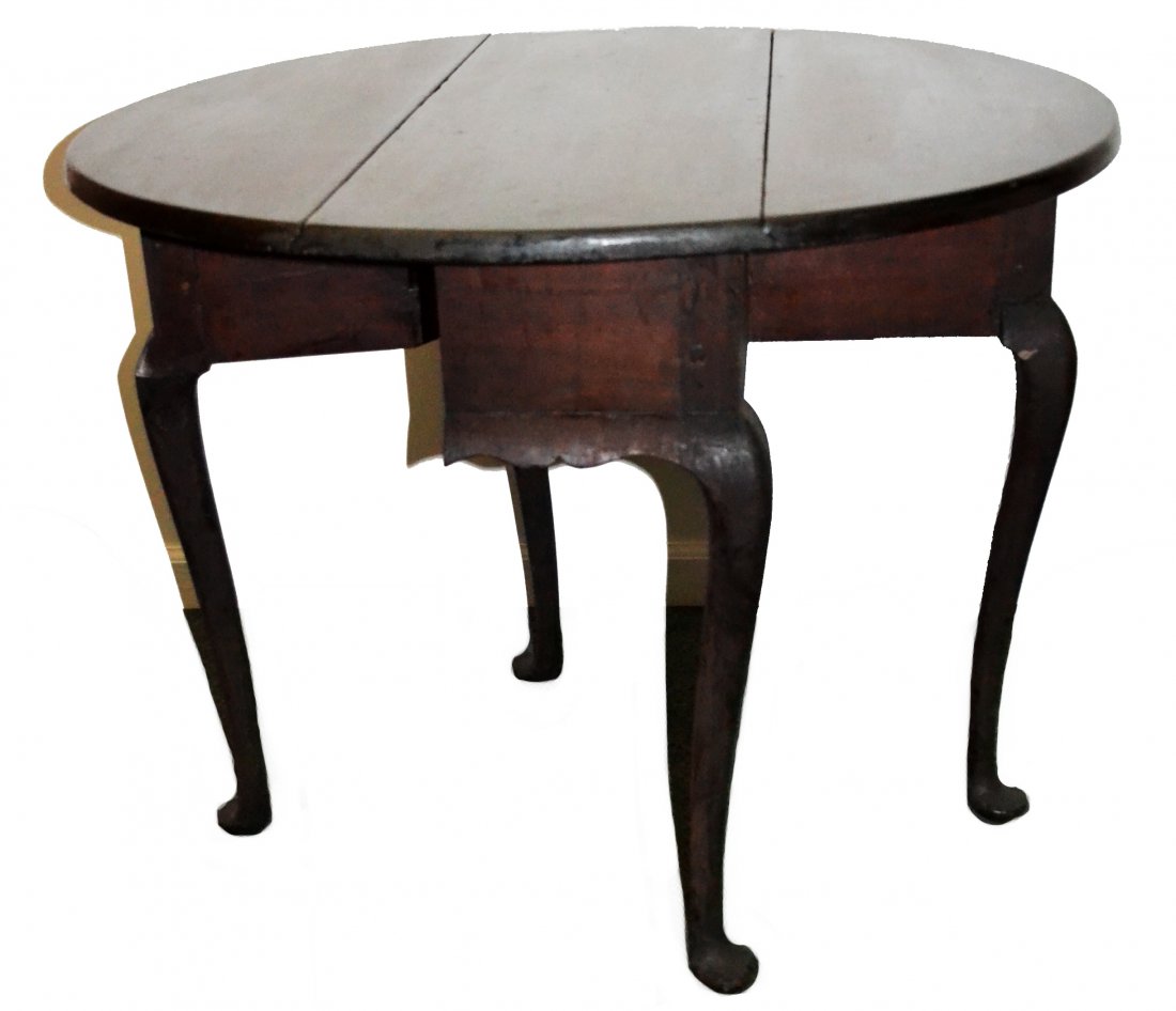 Table, New England Queen Anne, Maple: A period New England, maple Queen Anne drop-leaf table with old surface. The rectangular top with D shaped drop-leaves above a shaped apron. Raised on cabriole legs ending in pad feet. From the estate