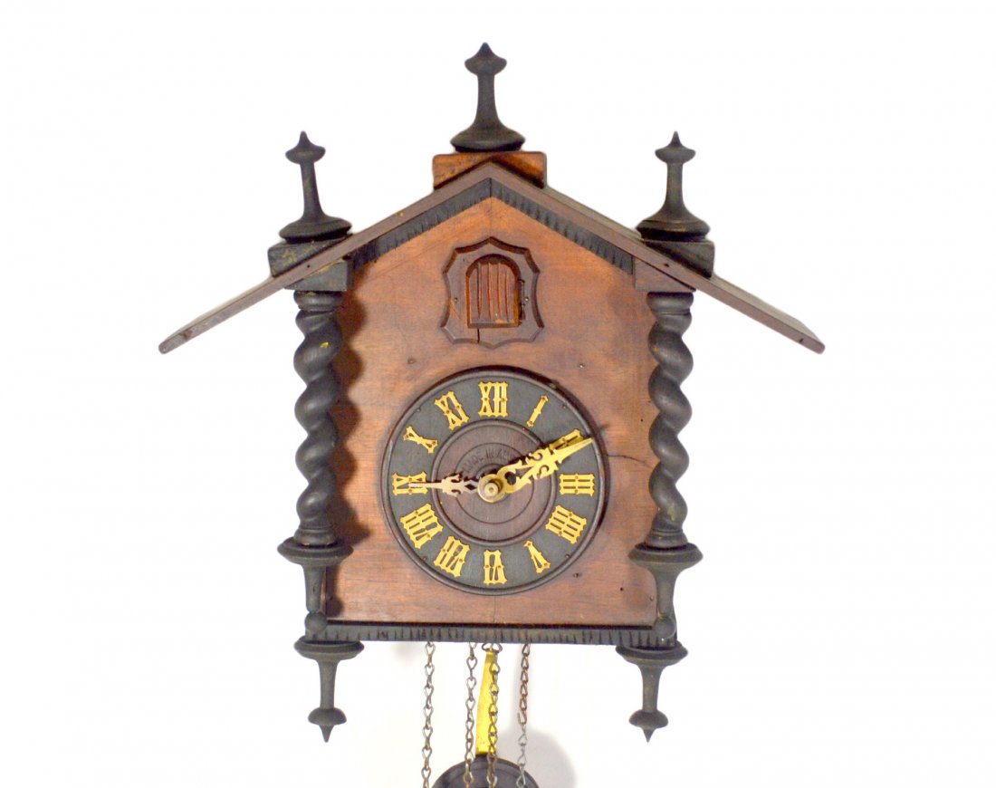 Clock, Cuckoo with spool-turned finials: Cuckoo clock with spool-turned finials,marked 'Made in Austria'. Size: 16" H. x 14.25" W. x 6.5" D. Weight: 10lbs