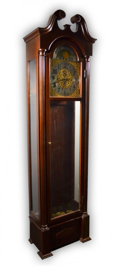 Clock, Tall Case, Herschede, Westminster Chimes: A Herschede tall case clock with Westminster Chimes. Plate glass cast with reeded split column decor. Broken arch pediment crest. Plinth block base. Gilt brass and steel face with brightly painted nig