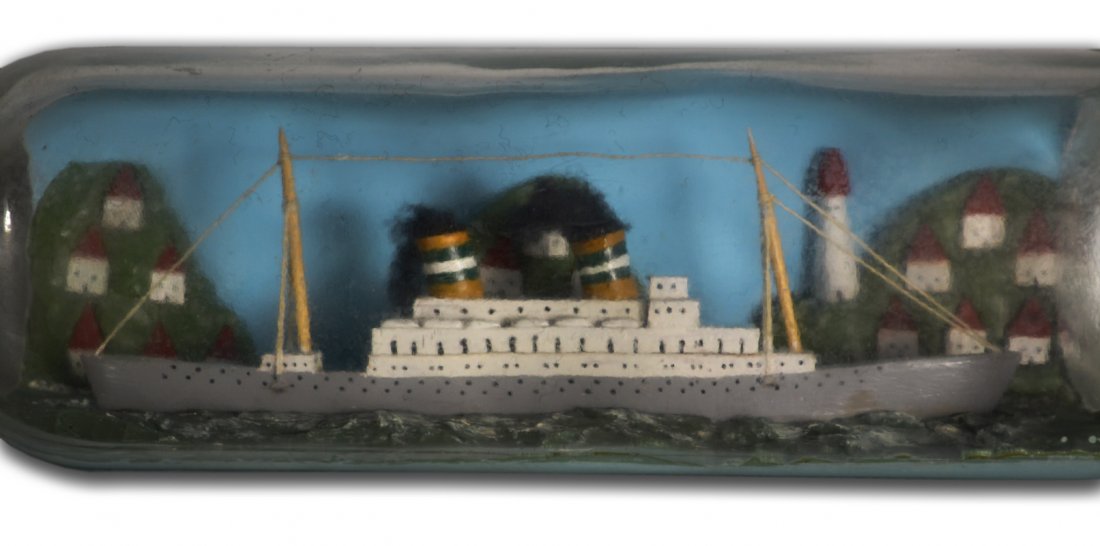 Ship in Bottle, Steamer, 2 stack with village: Ship in Bottle, Steamer, 2 stack with village, circa 1940. Gray & white transitional steamer displays two gold, green & white painted smoke stacks with black cotton simulating the smoke. It sits atop 