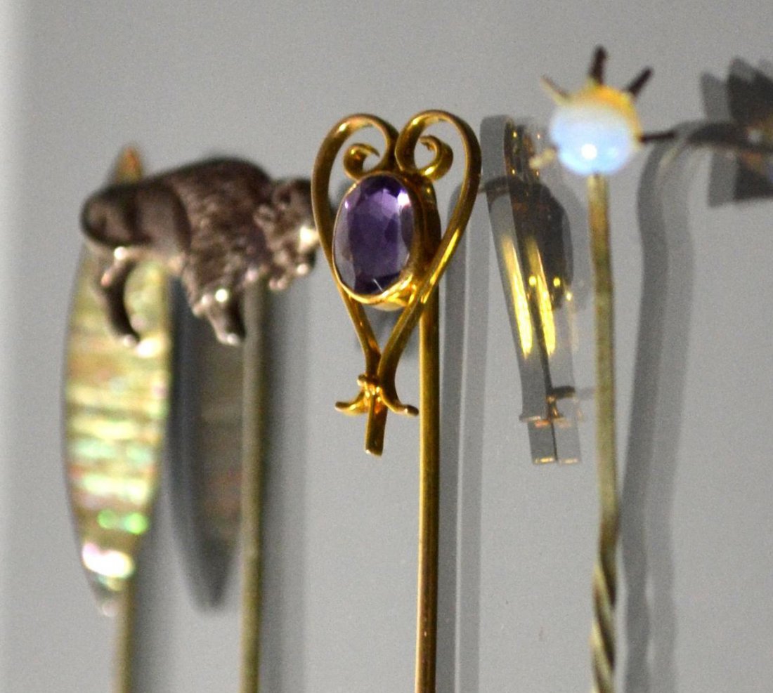 Stick Pins (4), 19th C, Mop, gold, silver, opal: Four 19th century stick pins. One silver with a buffalo, the second silver with an opal bead, one gold with an Amethyst, and the fourth silver with abalone. From a notable New England estate. Smallest