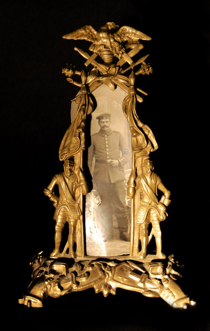 Picture Frame, Imperial German, WWI Brass: Picture Frame, Imperial German, WWI Brass frame with military figures on the edges, German eagle on top, with black and white photo of German officer. Provenance: Miki and James J. Mangan III of Fairf