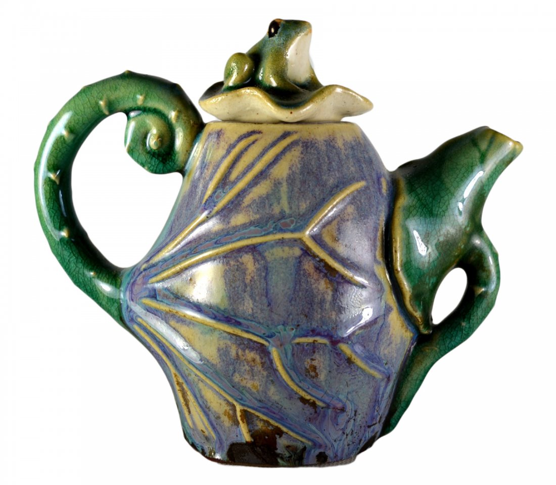 Pitcher, with frog lid, Majolica: Green and blue Majolica pitcher with frog lid circa 1900. Majolica is earthenware pottery made in 19th century Britain, Europe and the USA with molded surfaces and colorful clear lead glazes. Size: 6.