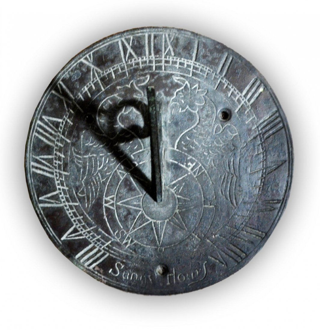 Sundial, 'Sunny Hours', Brass, 20th Century: A 20th century brass sundial. Has a griffin design with compass rose. Marked on the bottom 'Sunny Hours'. Size: 3.5" H x 6" Diameter x Weight: .75lb