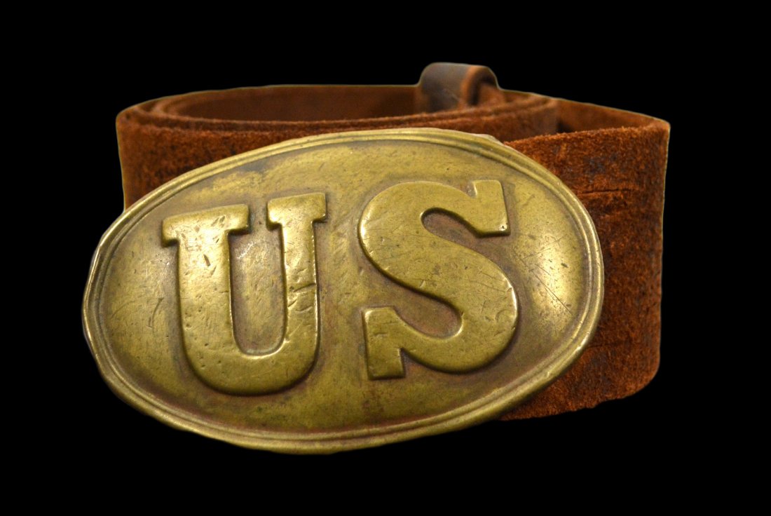 Belt plate, U.S., w/ orig. belt, Civil War: Brass U S belt buckle with lead backing mounted on the original leather. Arrow shaped hooks behind the 'S'. Civil War. Size: 40.75" L. x 1.75" W. , Buckle 3.25" W Weight: 7oz