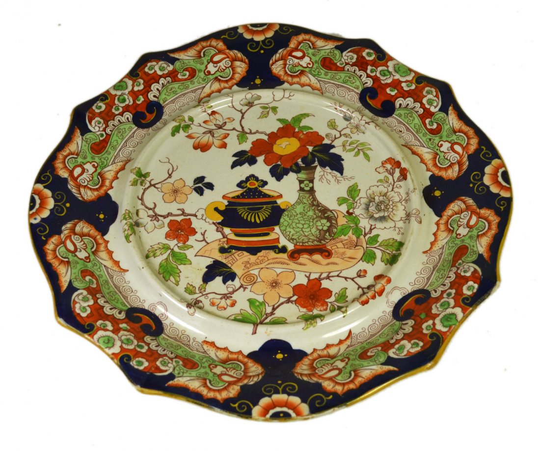 Plate, Mason's Ironstone, circa 1860: Plate, Mason's Ironstone, circa 1860 Form: Under plate Components: Hard paste Decoration: Hand painted floral and foliates with vase and jar at the center. Colors: Blue, red, green, yellow Markings: M
