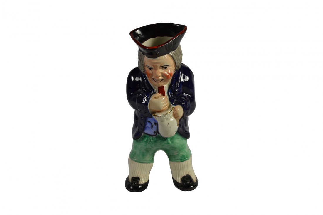 Toby Jug, Staffordshire, c 1850: Toby Jug, Staffordshire, c 1850 Form: Toby jug Components: Hard paste Decoration: Hand painted stout old man wearing a three cornered hat holding a pitcher with gold around the rim. Colors: Blue, red,
