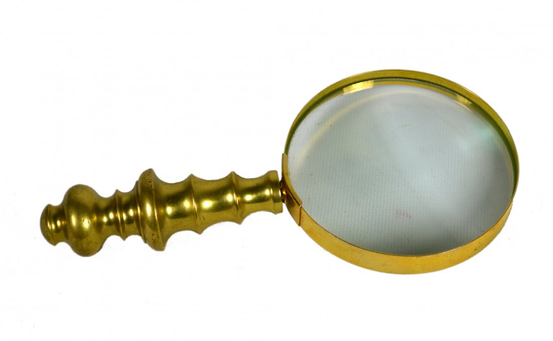 Magnifying Glass, Brass, Late 19th Century: Magnifying Glass, Brass, Late 19th Century Magnifying Glass Material: Brass and glass Construction: Cast handle, sheet brass rim & glass Marks: None Features: Rim which holds the glass screws into the